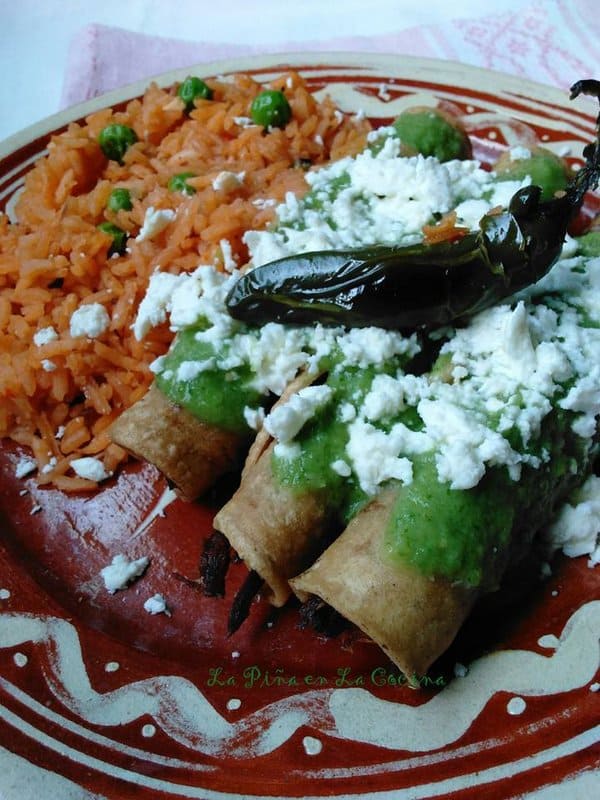 Beef Taquitos plated with rice and salsa