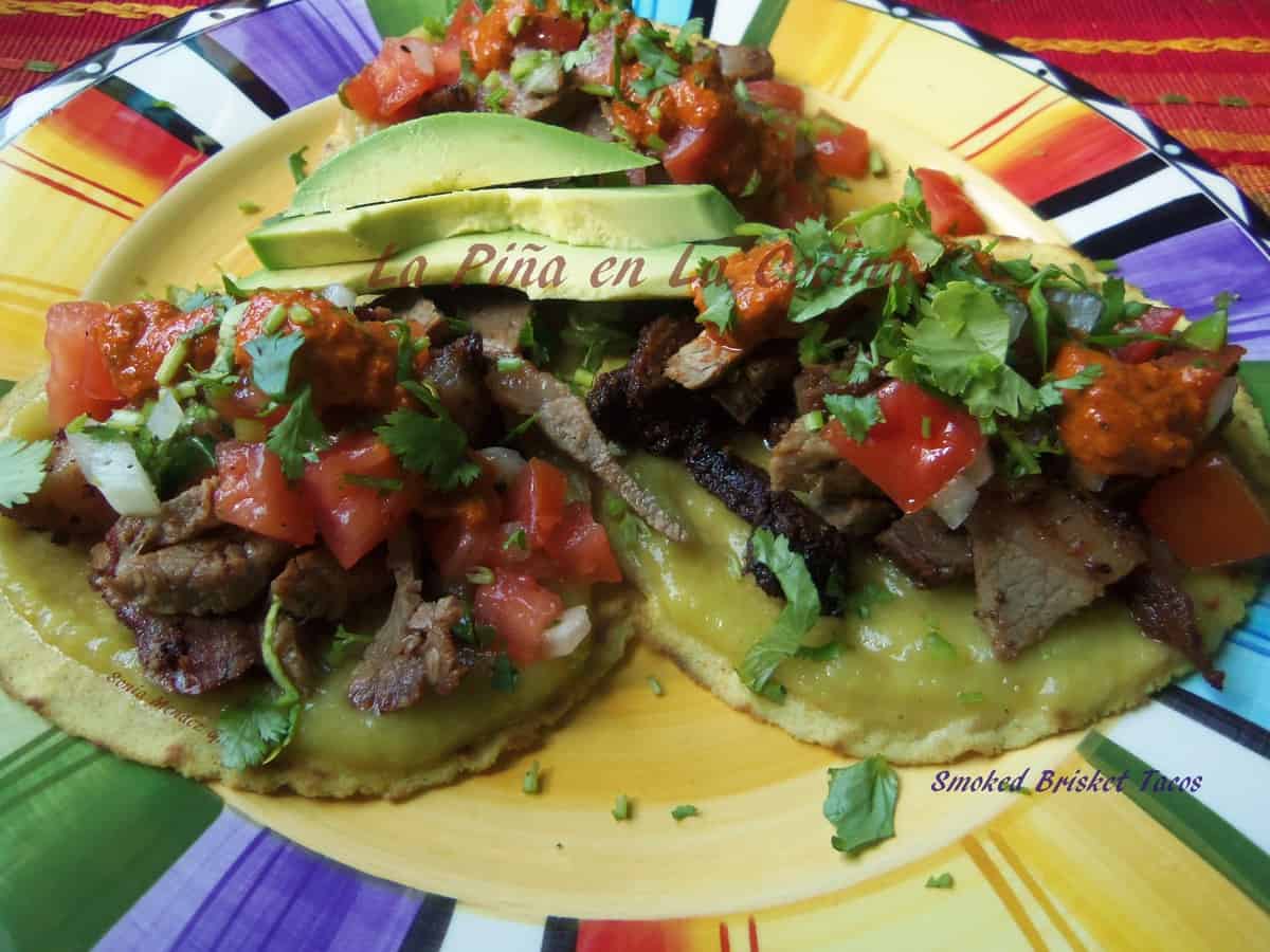 Smoked Brisket Tacos with fresh pico de gallo, toasted chile salsa and fresh corn tortillas.