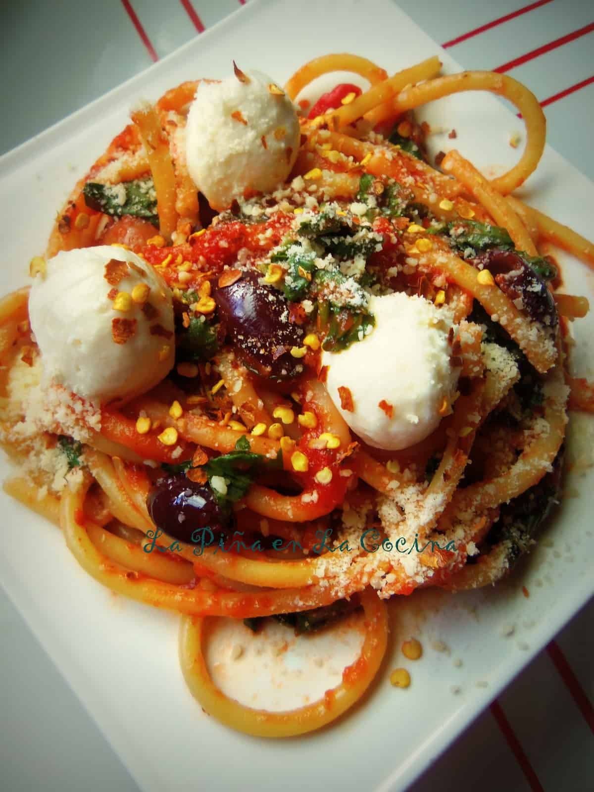 Fresh Mozzarella, Kalamata Olives, Garlic, Parmesan and Fresh Basil Tossed in with The Spicy Red Sauce and Spaghetti