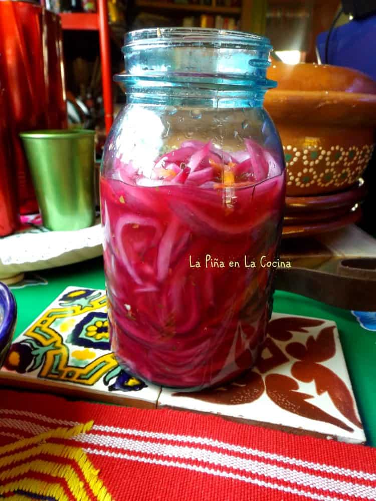 A jar of homemade pickled red onions with habanero