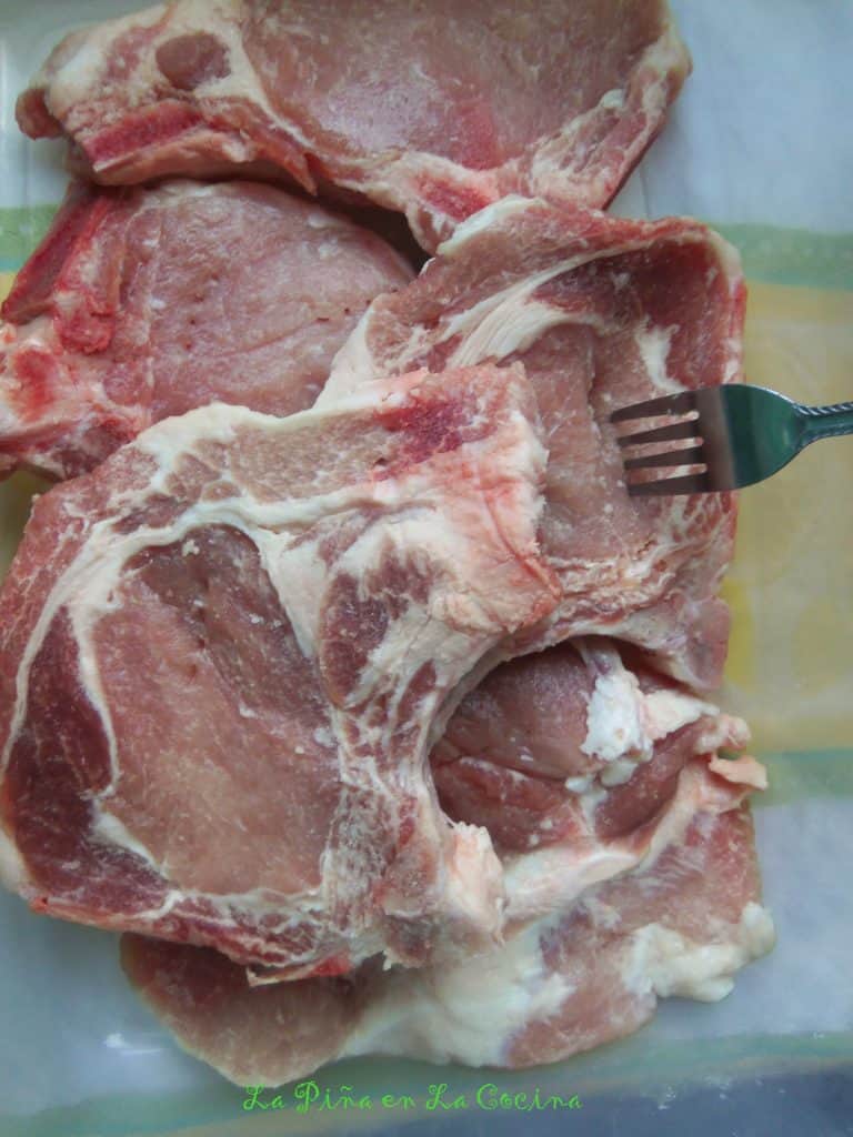 uncooked pork chops in baking dish