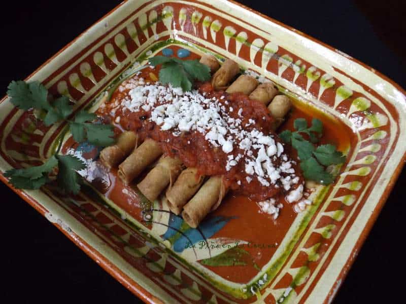 Codzitos on Mexican platter garnished with salsa, crumbled cheese and cilantro