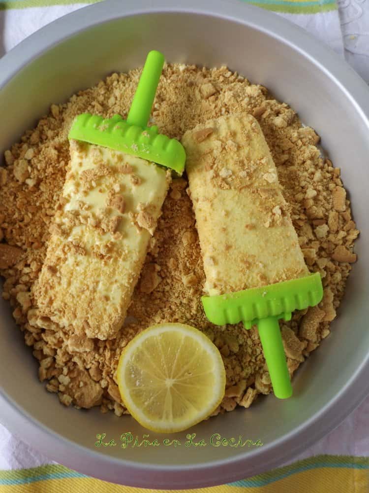 Pay de Limon Paletas-Lemon Pie Popsicles in pie plate with crushed Maria cookies