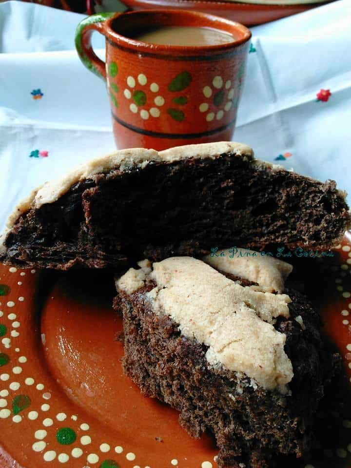 Dark Chocolate Conchas cut ope to expose beautiful chocolate bread with coffee cup on side