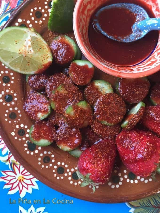 Cucumbers and strawberries drizzled with chamoy and sprikled with chile limon