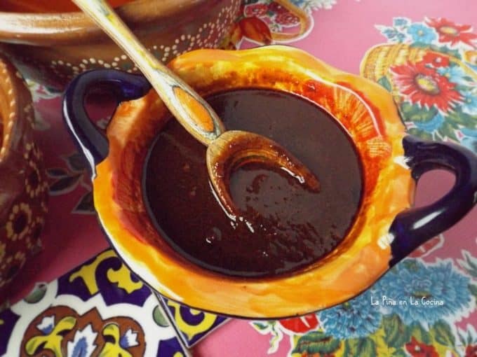salsa negra in a colorful bowl with wooden spoon