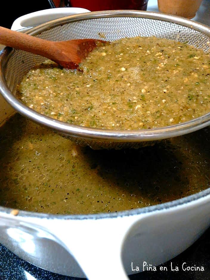 Straining Salsa Verde into pot of soup