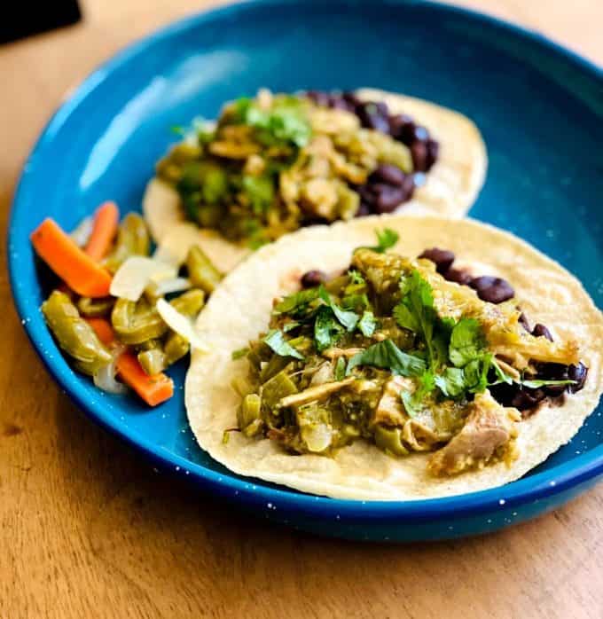 Tacos of pork in tomatillo salsa on a plate