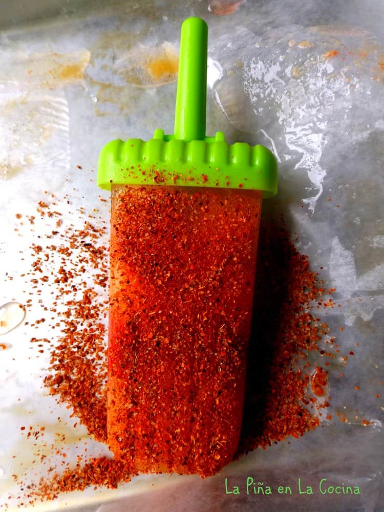Pineapple frozen paleta sprinkled with chile limon powder