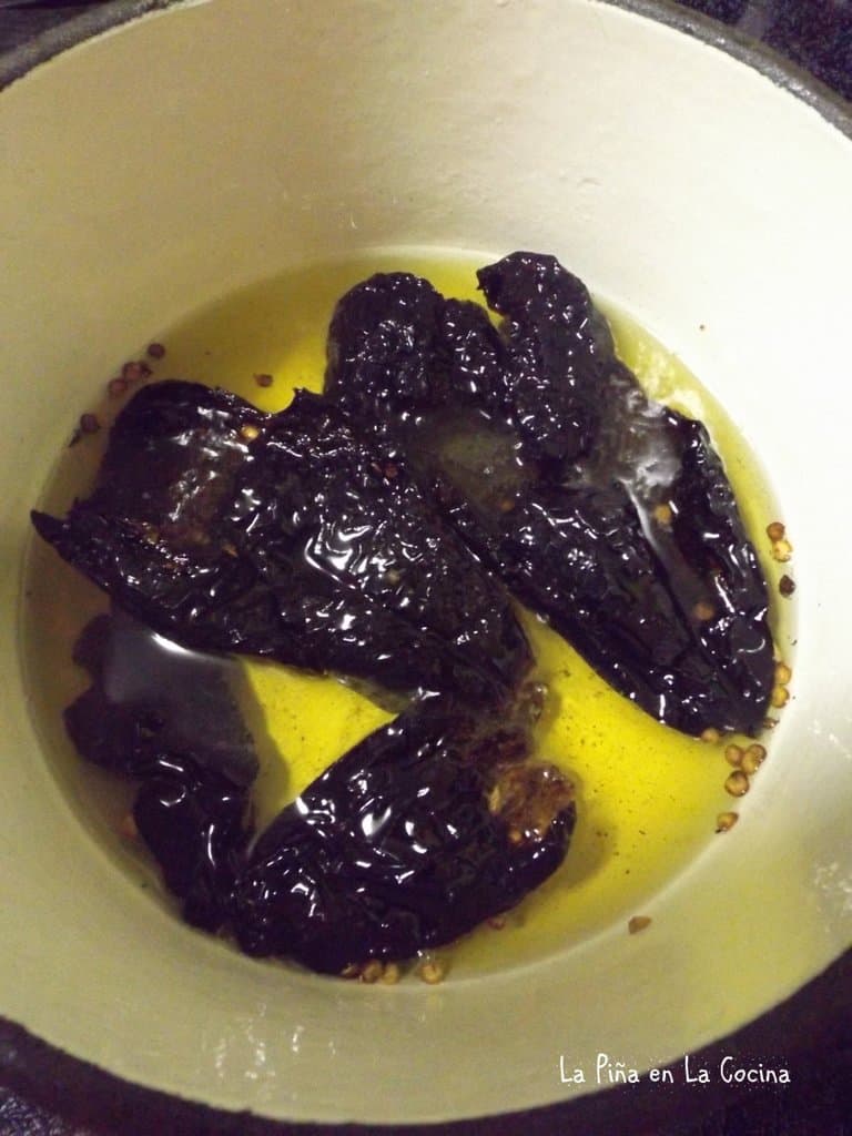 Dried chiles frying in oil 