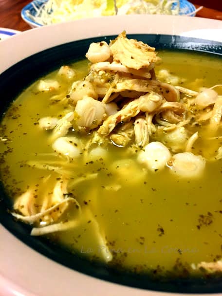 Green chile chicken pozole in a bowl before garnishes