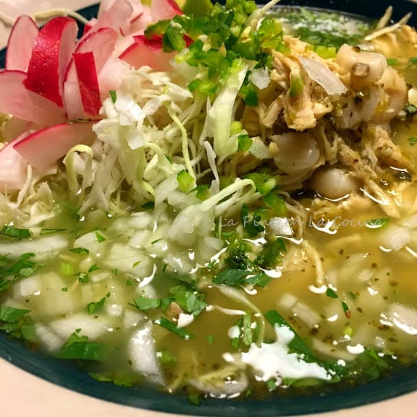 Pozole with garnishes in a big bowl