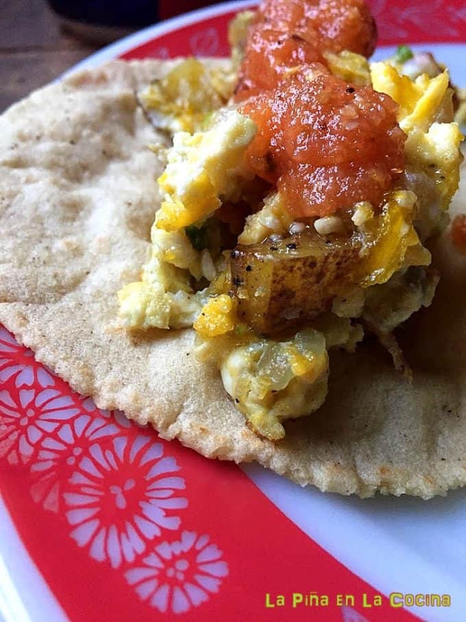Potato and egg scramble with salsa in a corn tortilla