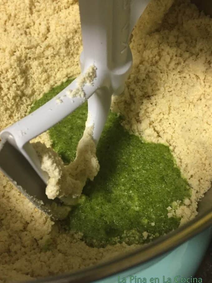 Adding green salsa to masa mixture in the stand mixer 