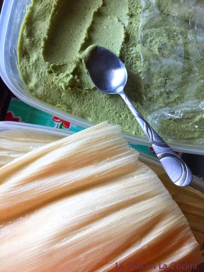 Softened corn husk and green chile masa with spoon