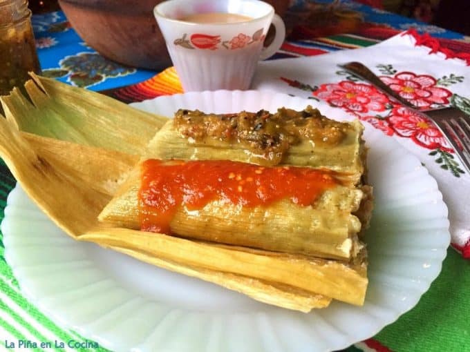 Tamales plated and garnished with salsa
