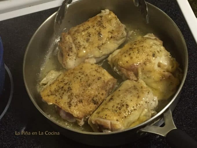 Seared chicken thighs in the skillet