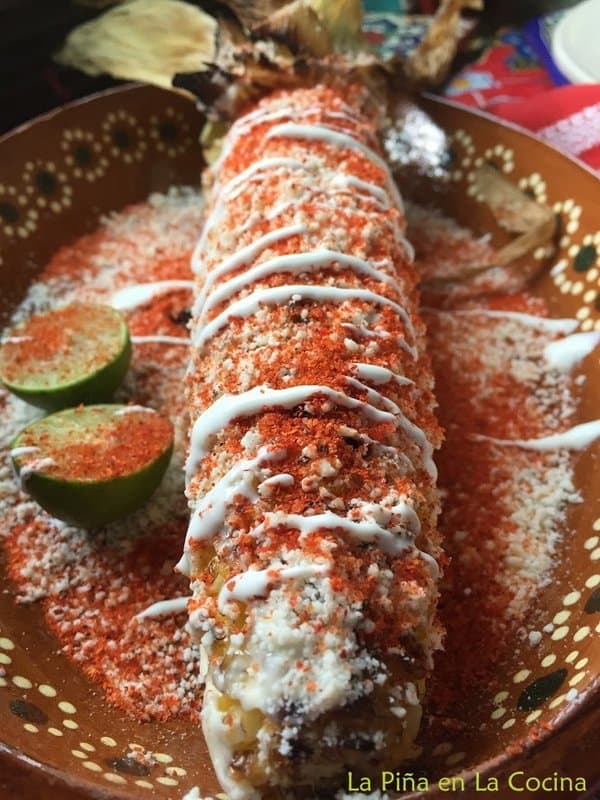 Grilled elote with all the toppings plated