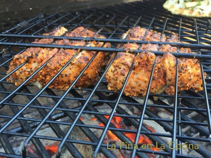 Sablefish in wire basket on charcoal grill