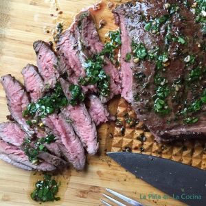 Grilled Flank Steak with cilantro Mojo Sliced on board