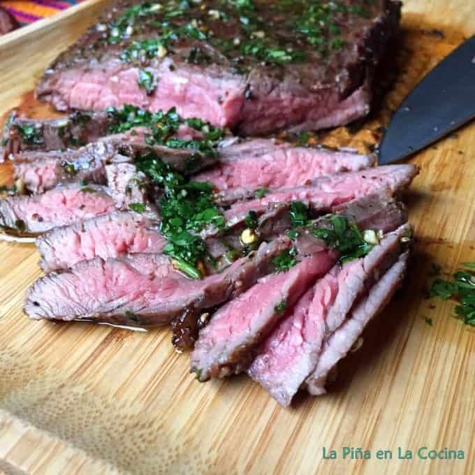 Sliced steak with Mojo on cutting board