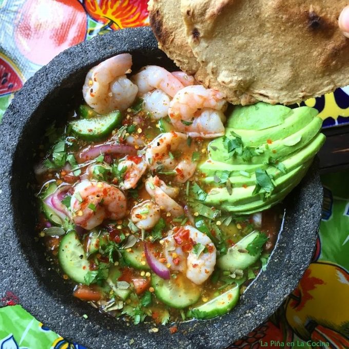 Top view shrimp aguachile with sliced avocado and tostadas