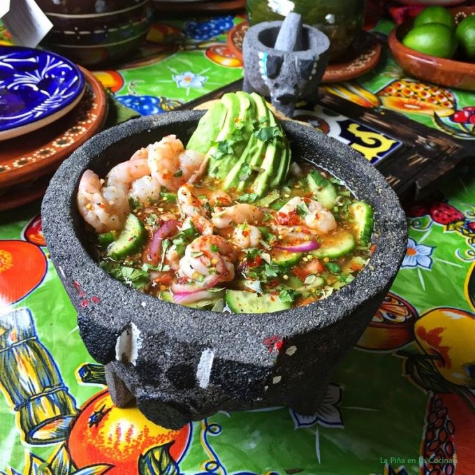 Shrimp aguachile in Mexican molcajete with vegetables and avocado