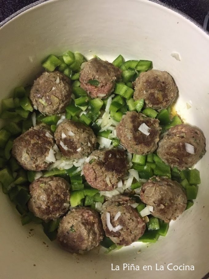 Browning meatballs with peppers and onions