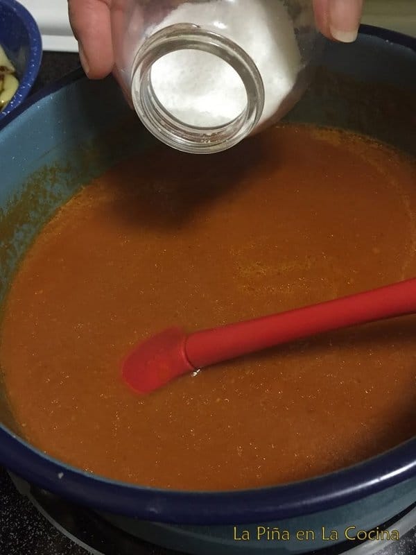 Guajillo salsa in sauce pan adding salt to taste