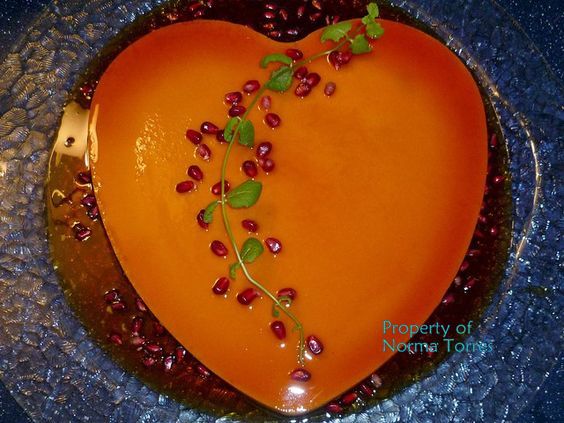 Heart shaped flan decorated with pomegranite seeds for Valentine's Day