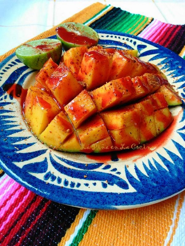 Fresh mango cut into cubes with chamoy sauce, lime and chile limon
