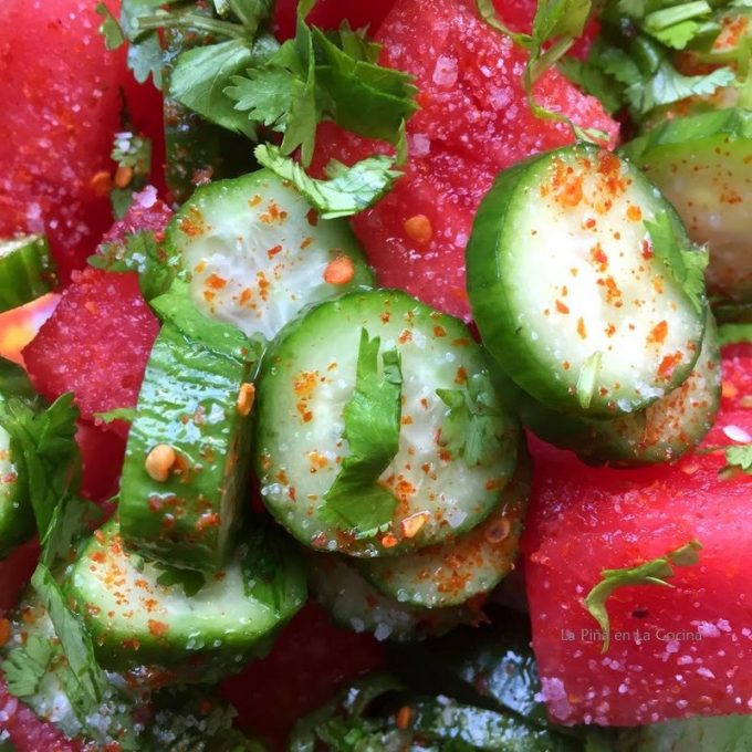 Cubed watermelon with baby cucumbers, cilantro, lemon, crushed red chiles and salt