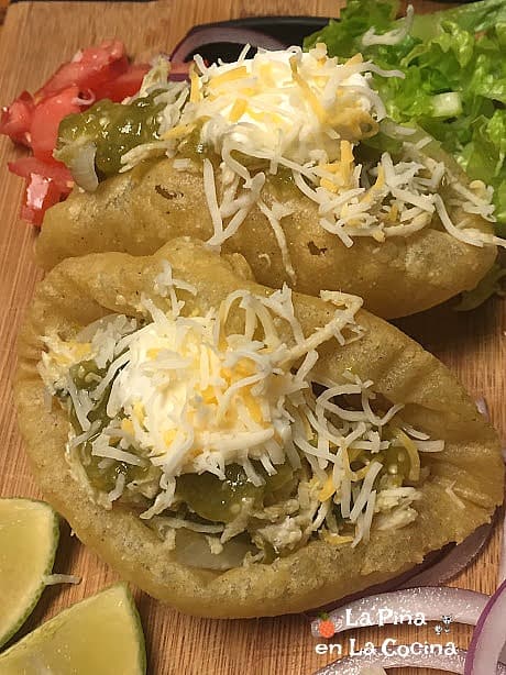 Puffy taco topped with fresh garnishes