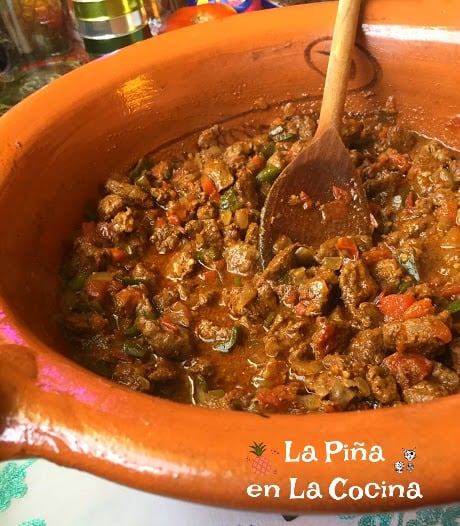 Large Mexican clayware pot filled with spicy marinated beef