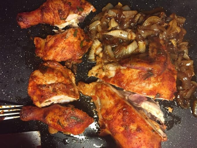 Roasted chicken sliced into pieces on cutting board