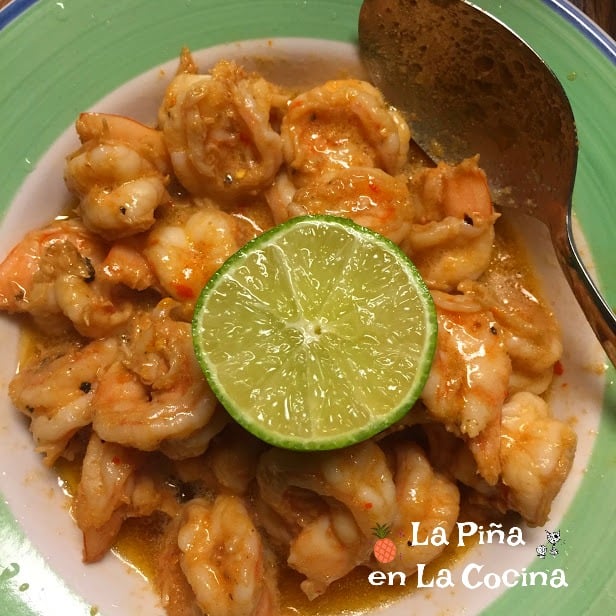 spicy butter shrimp in a bowl with half a lime