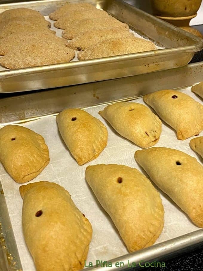 Freshly baked empanadas on baking sheet