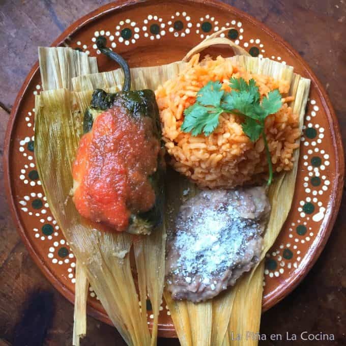 Tamachile garnished with tomato salsa. Served with a side of rice and beans