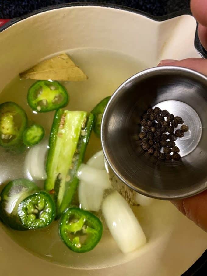 Adding spices to the warm brine