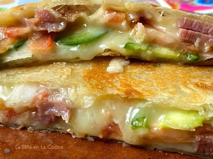 close up of sliced quesadilla with ham and cheese