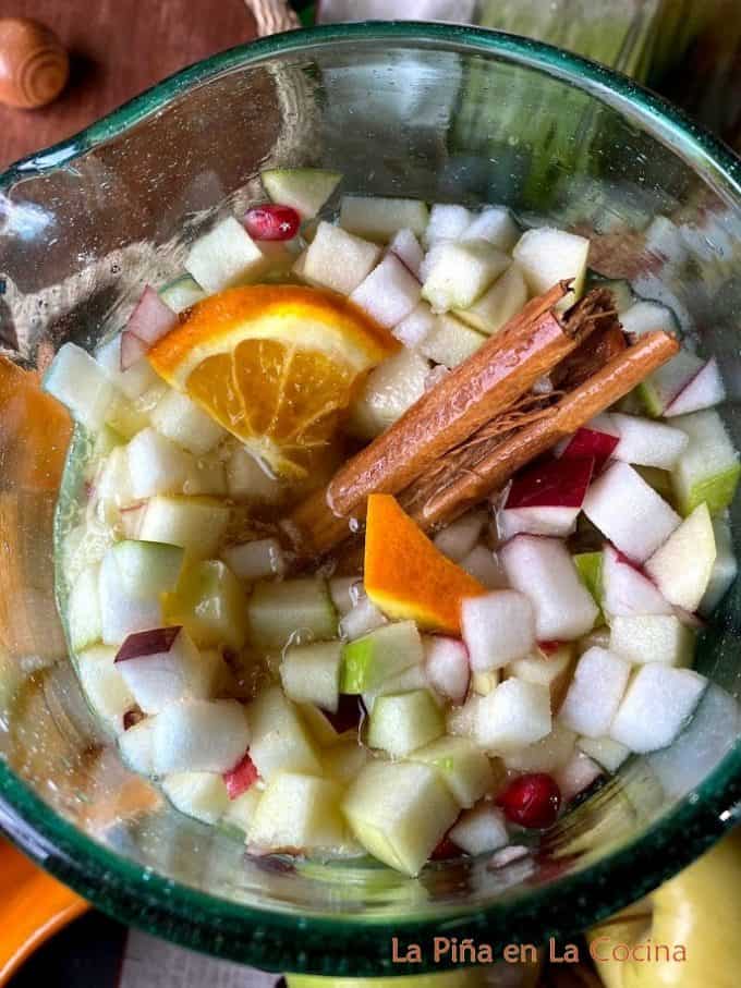 After mixing fall sangria, top view of pitcher full with cinnamon stick