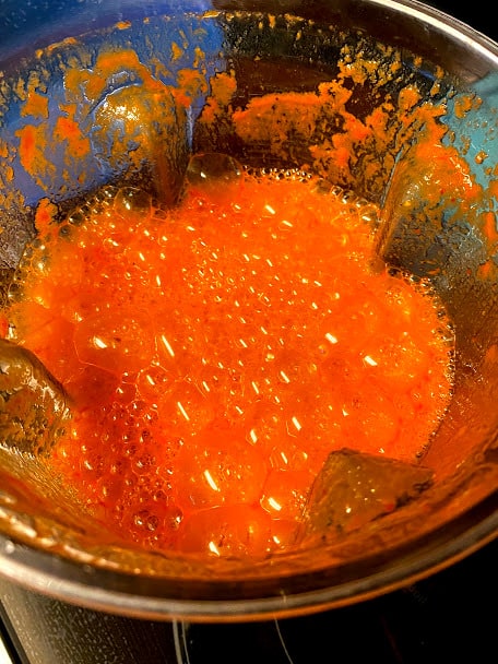 Blended red salsa in blender jar close up