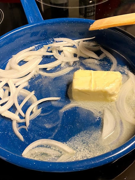 Onions with melting butter in saute pan