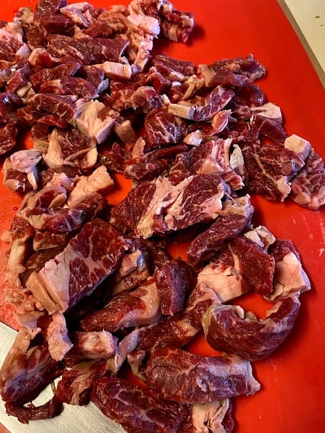 sliced chuck steaks on cutting board
