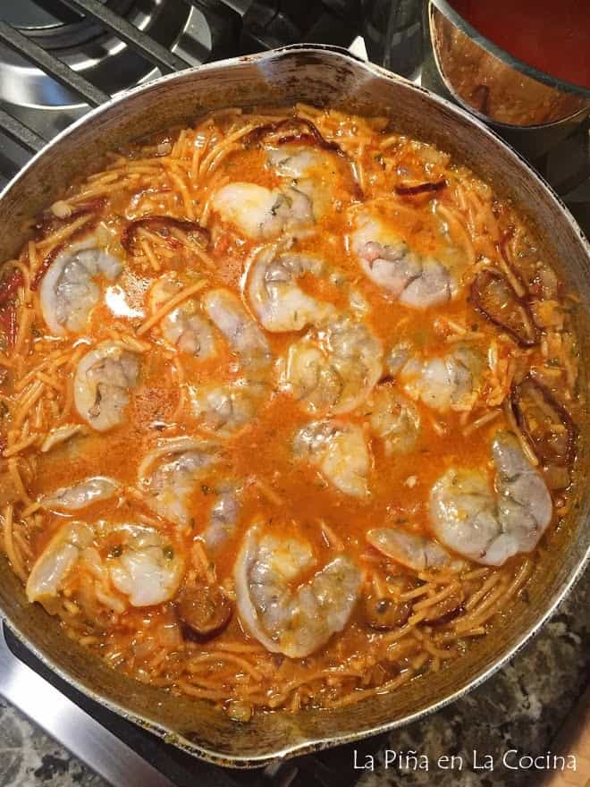 Added uncooked shrimp to fideo in skillet top view