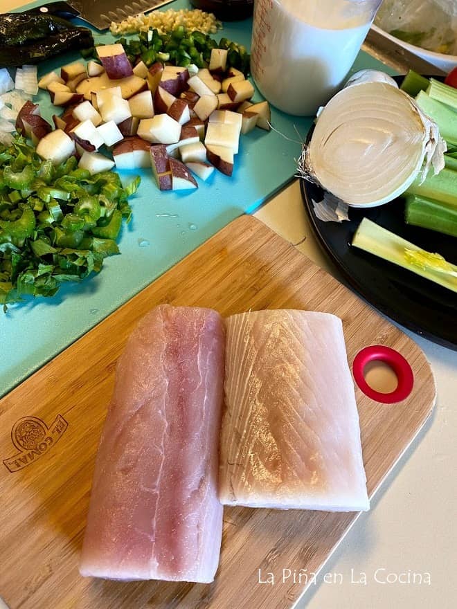 mahi mahi white fish filets with vegetable ingredients in the back round