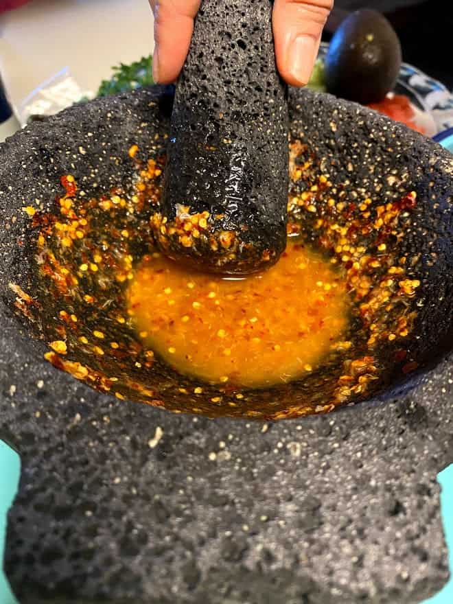 molcajete used to grind garlic with chile piquin. Added some lime juice