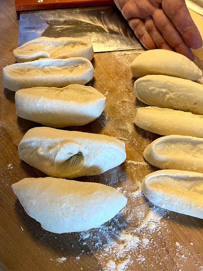 empanada dough divided into 10 pieces on cutting board