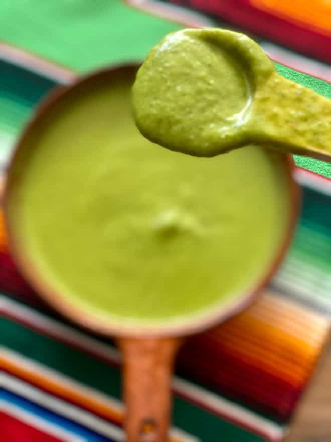 Salsa verde on a wooden spoon close up