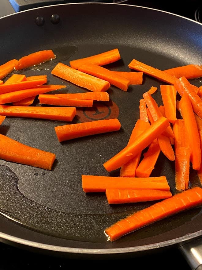 carrot sticks sauteed in oil in skillet